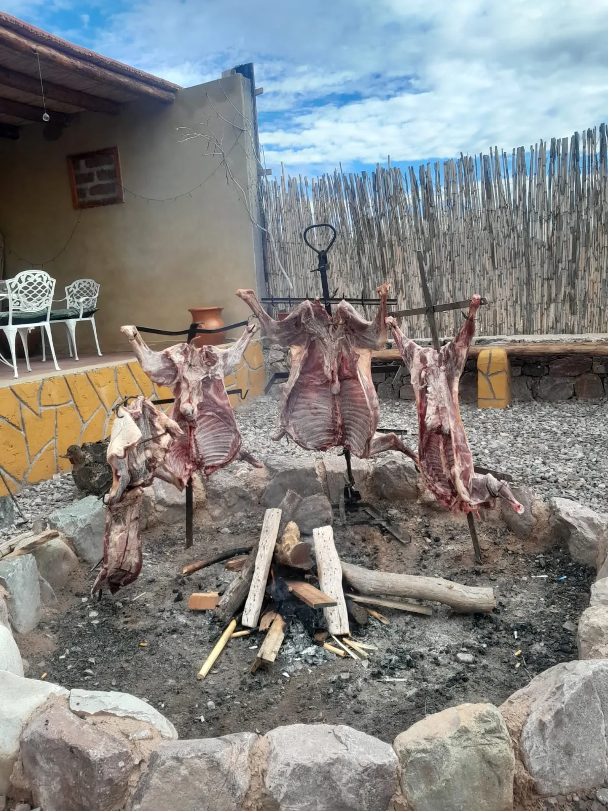 Asado a la estaca: cortes enteros alrededor del fuego, en el patio del complejo